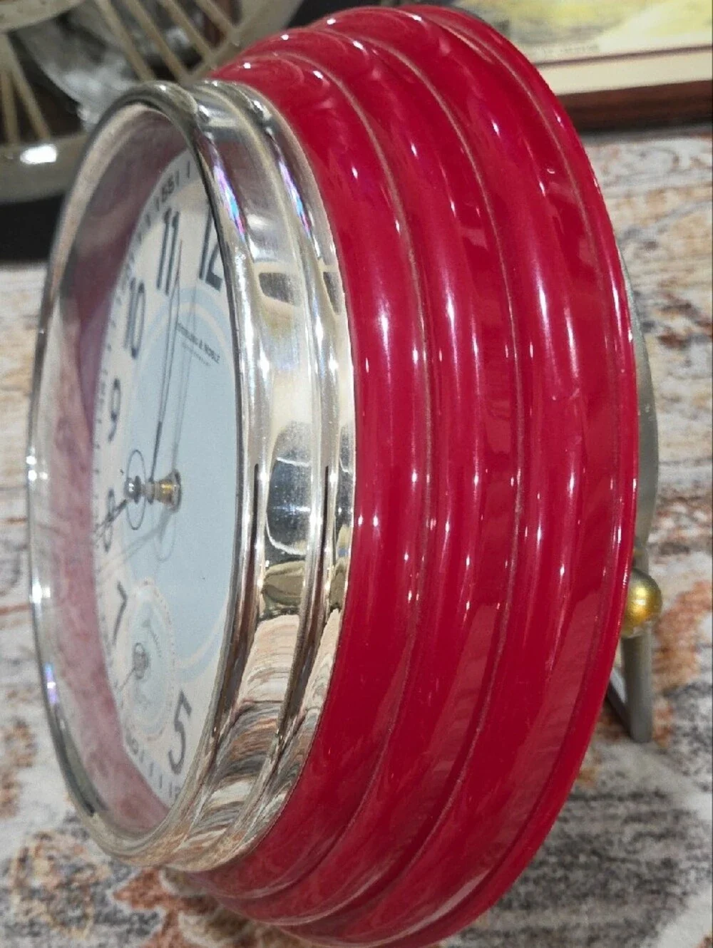 This is a retro-style decorative wall clock made by Sterling & Noble.